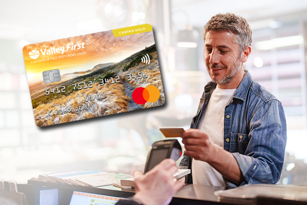 middle aged white man paying with his credit card at the till